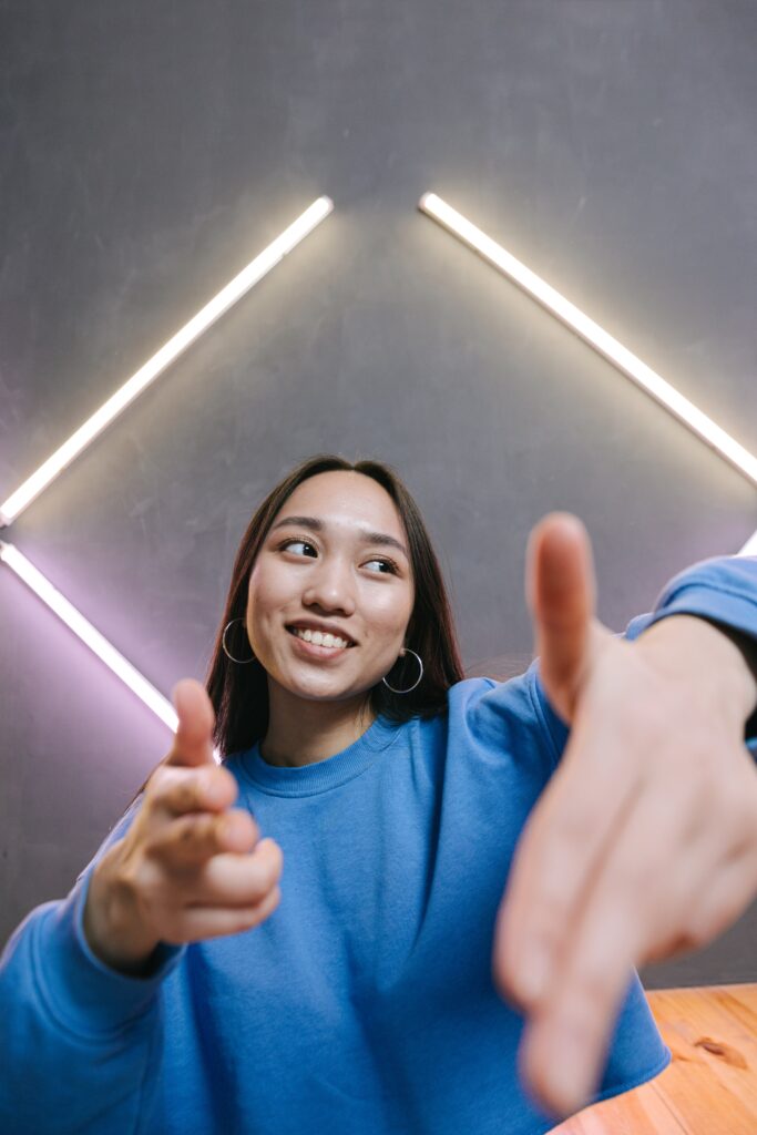 Woman in Blue Long Sleeve Shirt Smiling
