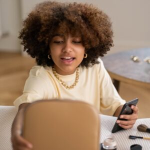 Woman Holding A Brown Makeup Kit